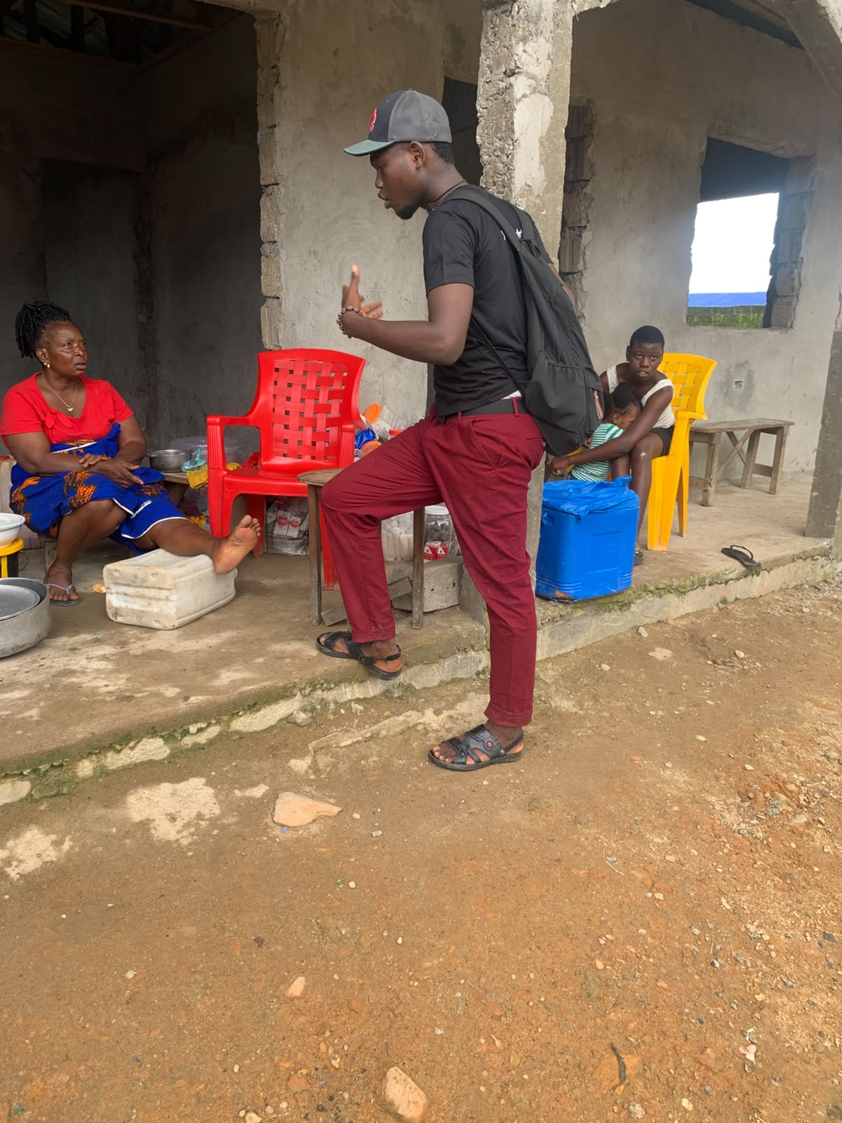 A Yinava field representative speaking with a household about LPG adoption